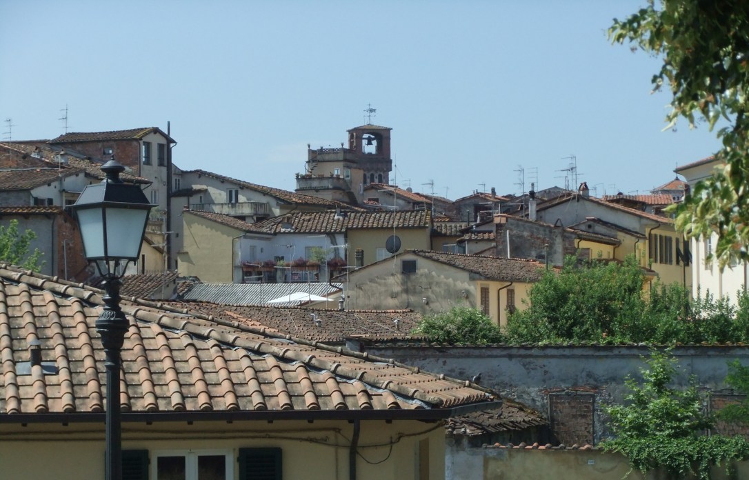 Roof tops leading to a Campanile in the distance. Lucca is noted for its many bell towers.